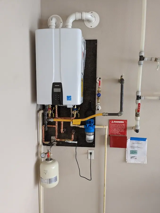 Professional plumber installing copper piping in a Suamico home
